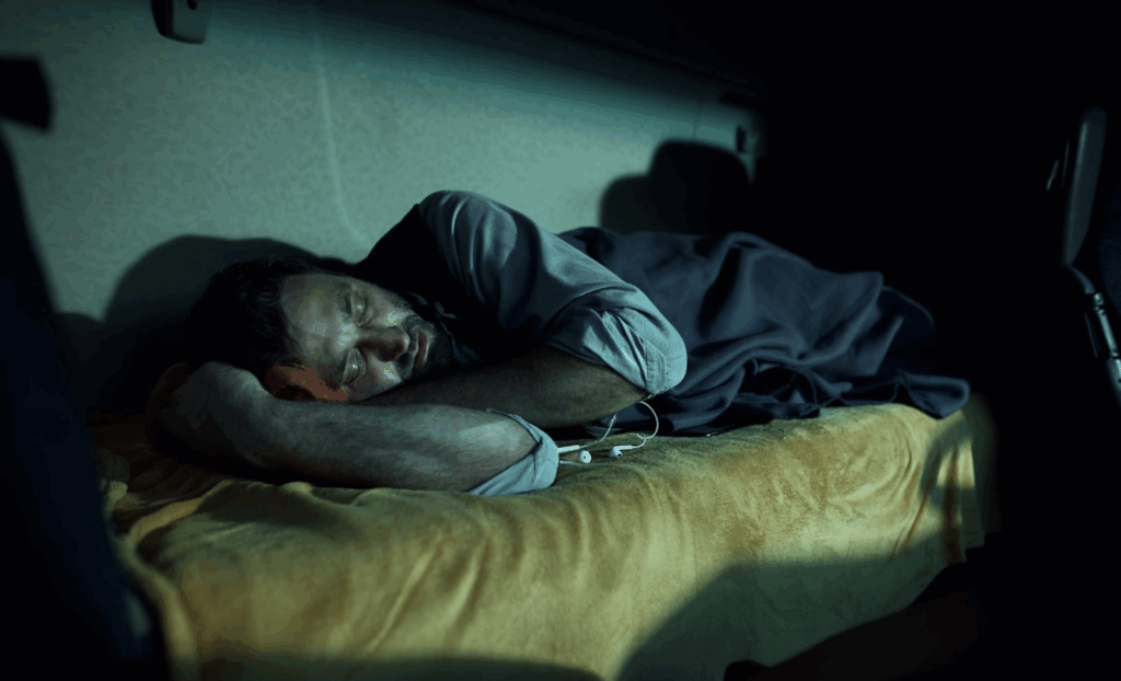  a truck driver sleeping in a cab